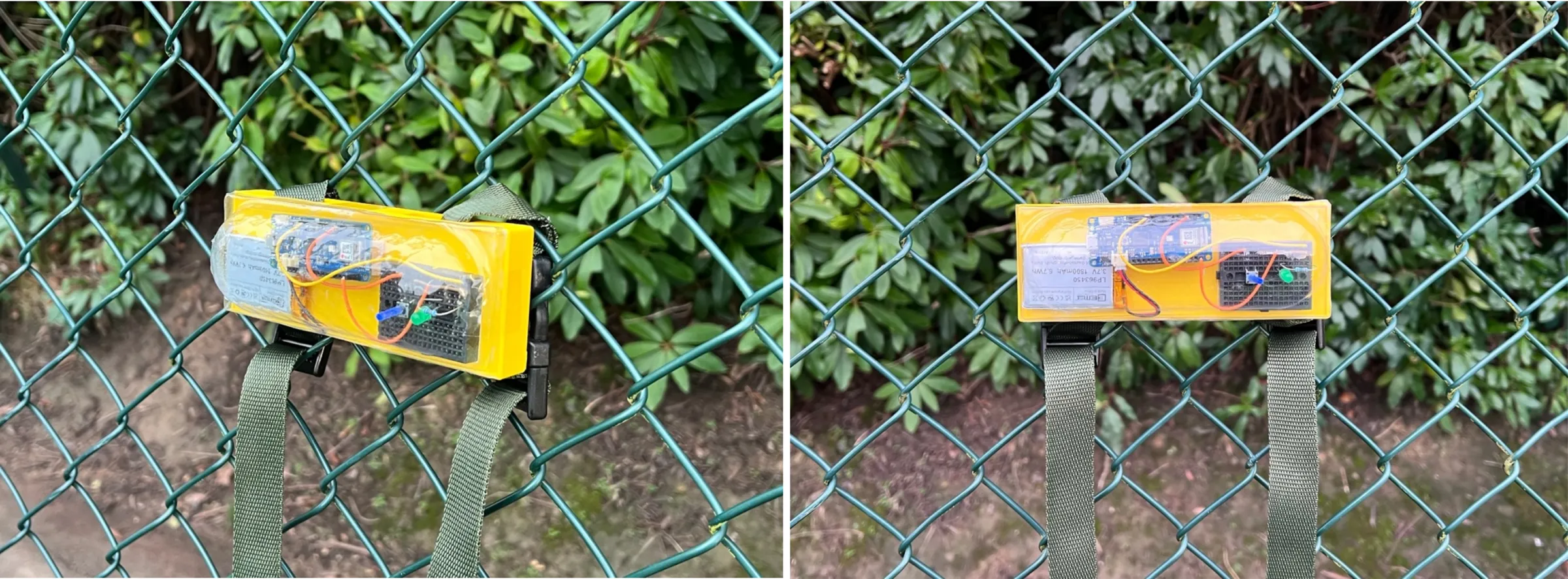 Two finished tiles, yellow with clear covers, strapped to the chain-link fence of a tennis court.