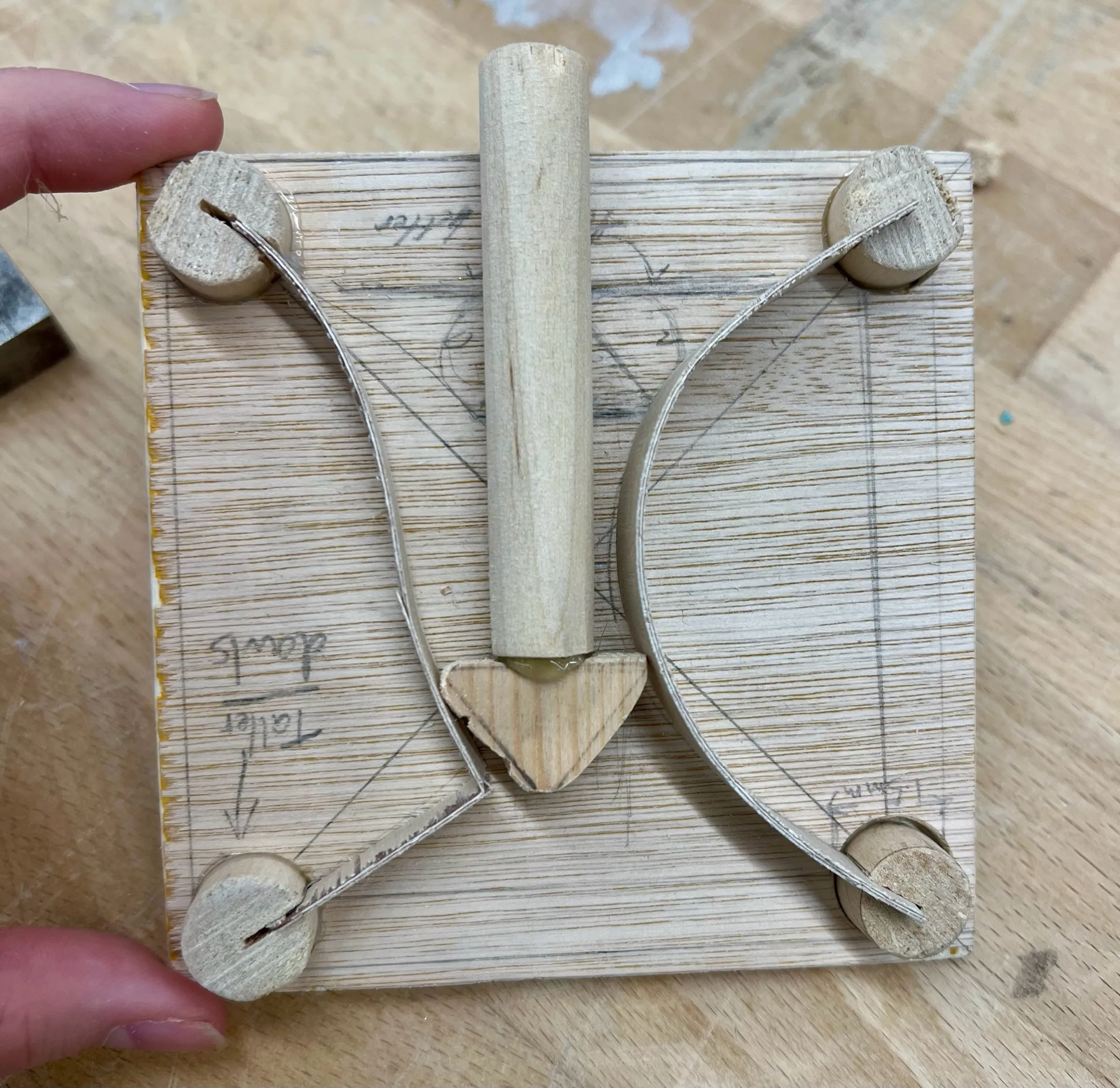 A later test piece: the central dowel now ends in a triangular wooden tip between the two curved strips.